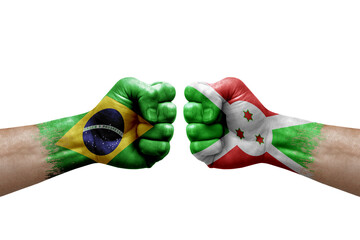 Two hands punch to each others on white background. Country flags painted fists, conflict crisis concept between brazil and burundi