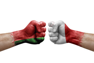 Two hands punch to each others on white background. Country flags painted fists, conflict crisis concept between belarus and malta