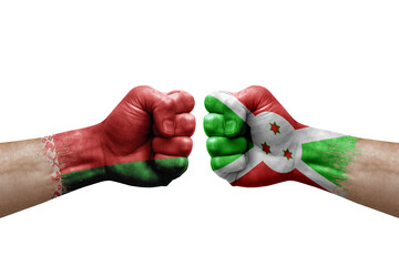 Two hands punch to each others on white background. Country flags painted fists, conflict crisis concept between belarus and burundi
