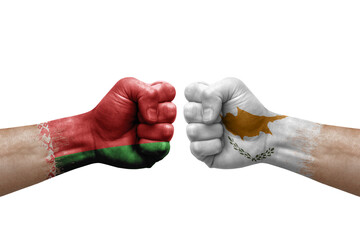 Two hands punch to each others on white background. Country flags painted fists, conflict crisis concept between belarus and cyprus