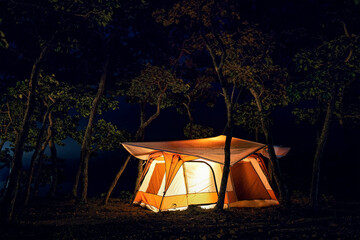 Tourist tent in the forest at night. Camping at night