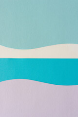 paper design suitable as a background with blank space featuring undulating lines in blue and mauve