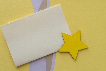 wooden star painted yellow, blank space, and design in yellow, mauve, and beige