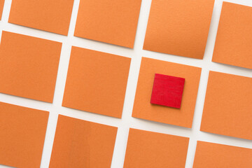 wooden square on orange paper