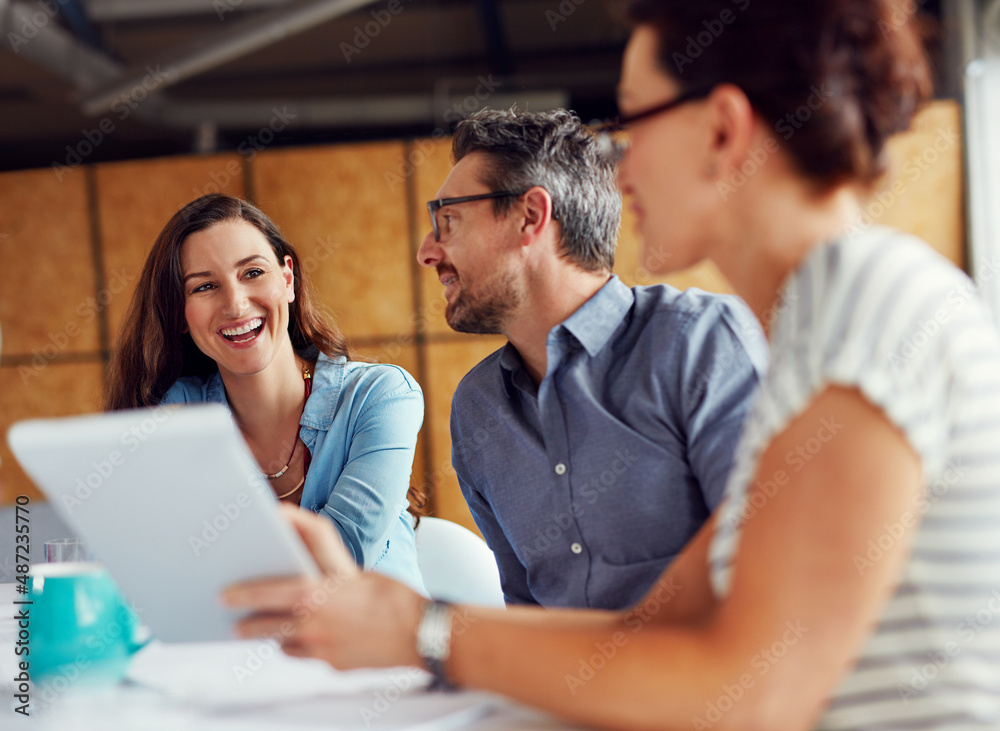 Poster making tomorrows success today. shot of a group of coworkers having a meeting in an open plan office