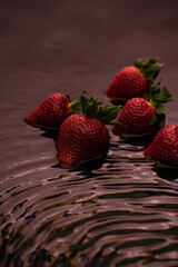 Fresh strawberries on a dark background with reflection