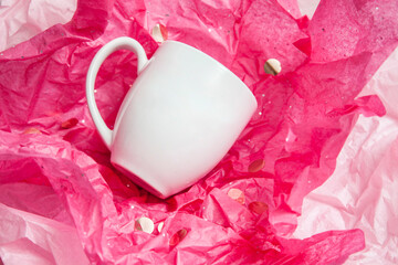 white porcelain coffee drink cup mug on pink gift wrapping paper
