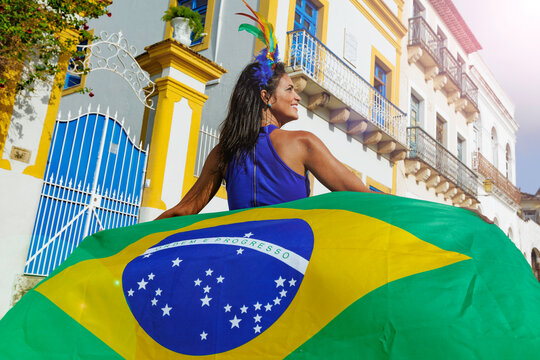 Beautiful Woman fun of the Brazilian soccer team celebrating in the street. Dressed in the colors of Brazil.