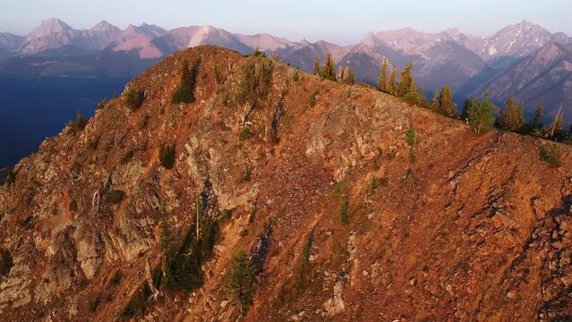 Golden hour orbiting around the mountain in South Rockies, BC, aerial shot, 001