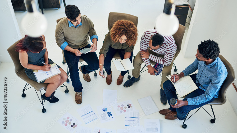 Poster theyre a results driven team. shot of a group of colleagues having a meeting in a modern office.