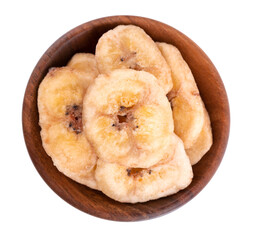 Banana chips in wooden bowl, isolated on white background. Dried fruit snack. Top View.