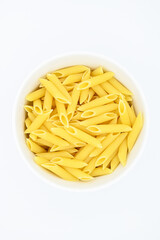 Raw penne rigate pasta, in a white bowl, isolated on a white background
