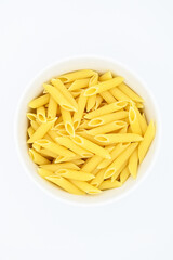 Raw penne rigate pasta, in a white bowl, isolated on a white background
