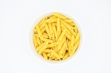 Raw penne rigate pasta, in a white bowl, isolated on a white background
