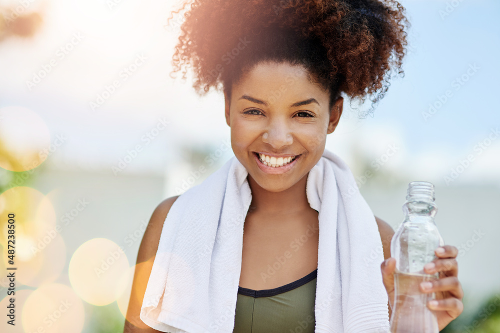 Canvas Prints The importance of drinking water cannot be emphasized enough. Cropped shot of a young woman enjoying a bottle of water while out for a run.