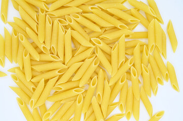 Raw penne rigate pasta, isolated on a white background
