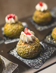 Beautiful multicolored decorated baked sweet tasty candy bar dessert on kids children party with happy people around, catering banquet table on kids children party