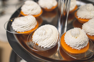 Beautiful multicolored decorated baked sweet tasty candy bar dessert on kids children party with happy people around, catering banquet table on kids children party