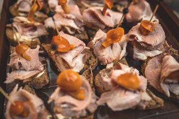 Catering table, beautifully decorated banquet with variety of with different food snacks and appetizers on corporate birthday party event or wedding celebration, canape, delicatessen setting