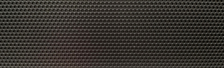 Black abstract metal surface with holes like a grid.