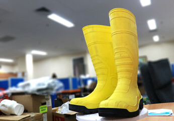 Photo of yellow rubber boots, these boots are usually worn by workers, these shoes include safety...