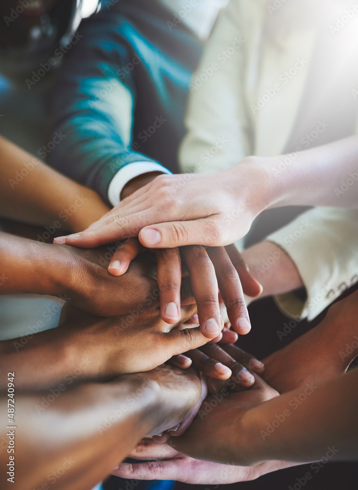 Poster Unity is strength. Cropped shot of a group of businesspeople piling their hands on top of each other.