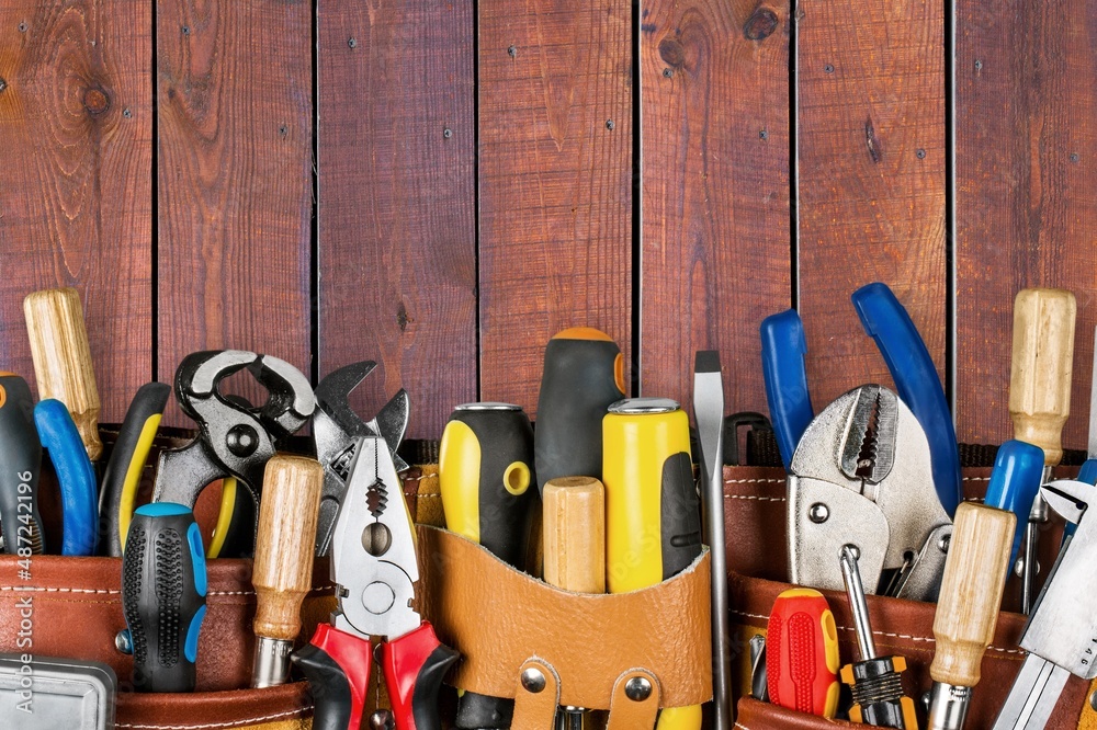 Sticker tool belt with tools on wooden background