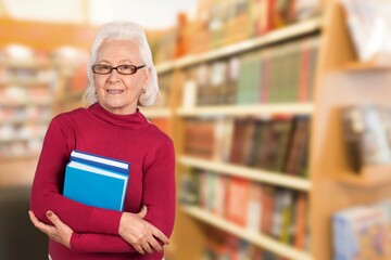 Mature student woman smiling looking at camera with books
