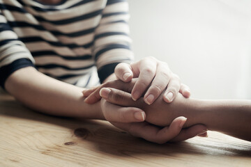 Im here for you. Shot of an unidentifiable woman consoling her friend by holding her hand.
