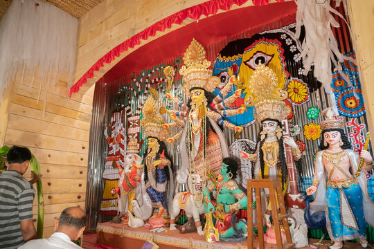 KOLKATA , INDIA - SEPTEMBER 26, 2017 : Goddess Durga idol inside decorated Durga Puja pandal, shot at colored light . Durga Puja is biggest religious festival of Hinduism.