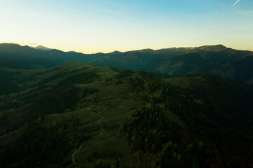 Aerial view of beautiful mountain landscape with village at sunrise