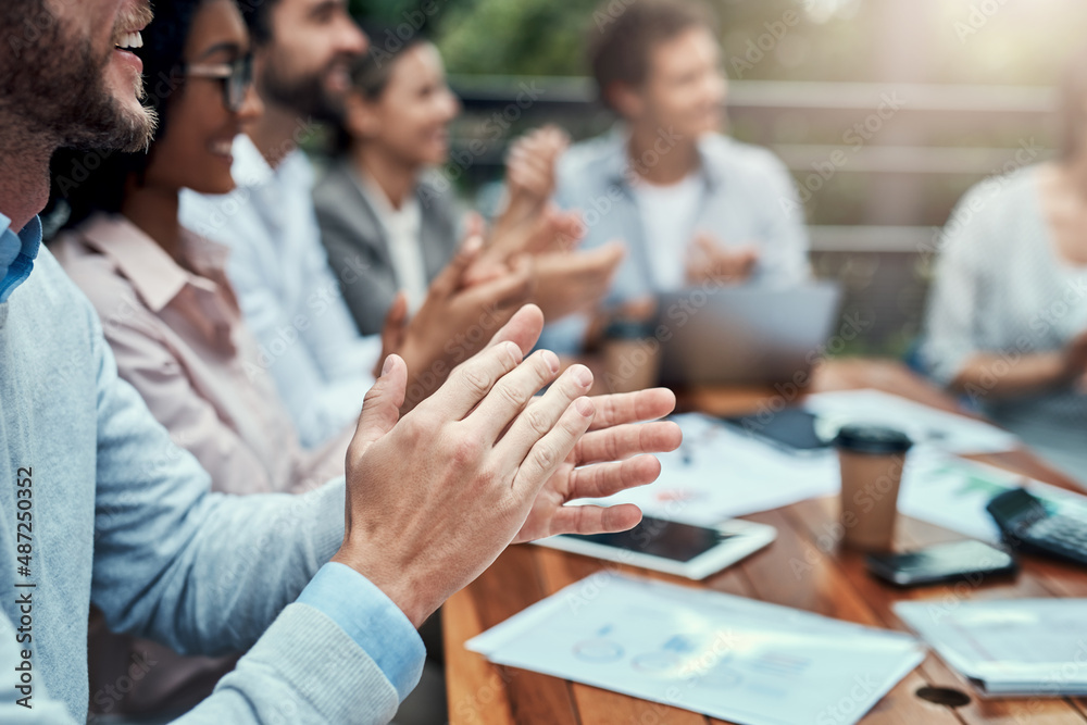 Poster ready with their round of applause. shot of a group of colleagues applauding during a meeting at a c