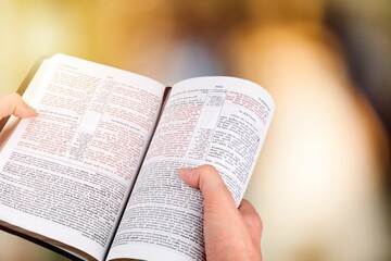 Fototapeta premium A human holding and read book with window light, crisis solution pray to God, Christian