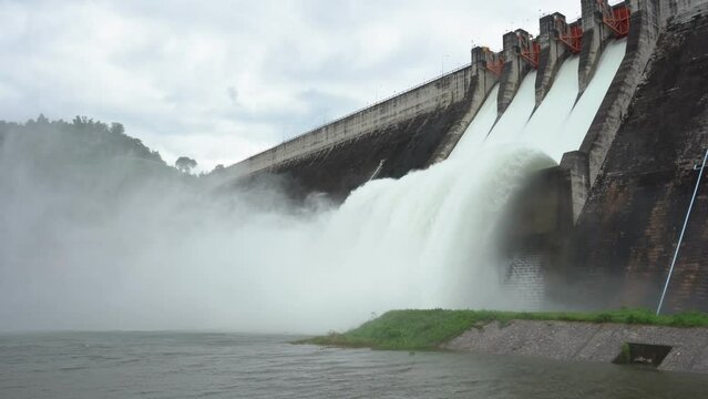 Hydroelectric dam Floodgate with flowing water through gate and Open the springway Khun Dan Prakan Chon Dam in nakhon nayok Thailand