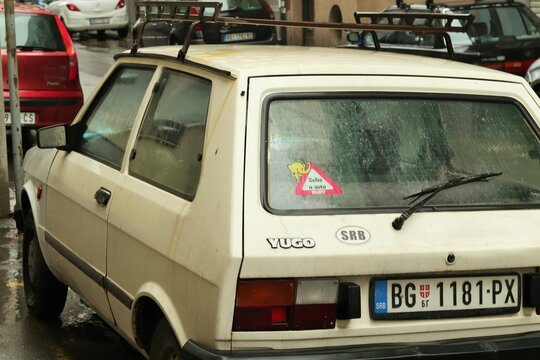 Retro car YUGO made in Yugoslavia on a city street