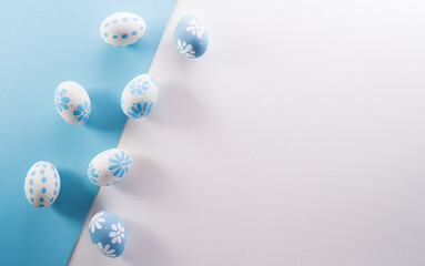 Happy easter! colourful Easter eggs on pastel blue and white background.