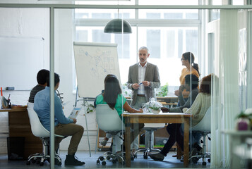 He has their full attention. Shot of a group of coworkers in a boardroom meeting.