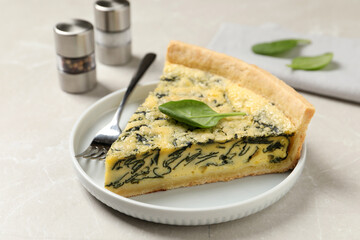 Piece of delicious spinach pie served on light marble table, closeup