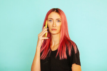 a woman with pink hair is talking on the phone in the background