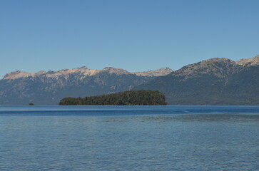 Fototapeta na wymiar Some mountains and an island in the background of Lake Correntoso, in Argentine Patagonia