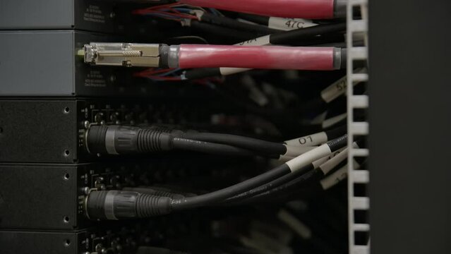 Cables and Optical Fiber Cable Connectors Plugged Into Large Data Center Server