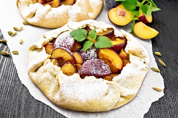 Galeta two with plums on wooden board