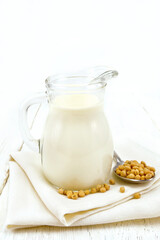 Milk soy in jug on wooden board