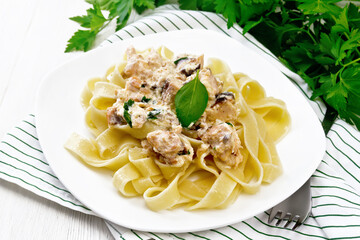 Pasta with salmon in cream on light board