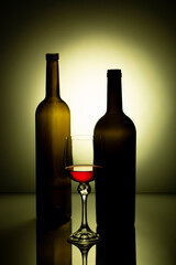 Still life with glass bottles and wine glass