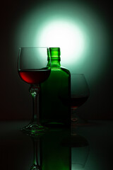 Still life with glass bottle and wine glasses