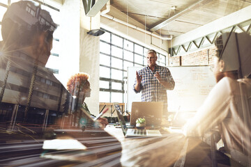 This is the great big plan. Multiple exposure shot of businesspeople having a meeting superimposed...