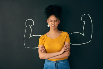 Sometimes being strong is the only choice you have. Shot of a woman posing with a chalk...