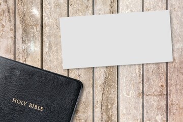 Concept of message on wooden background with closed Bible. God Jesus Christ