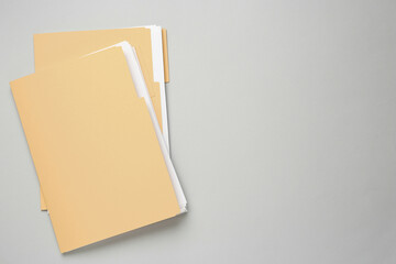 Yellow files with documents on light grey background, top view. Space for text - obrazy, fototapety, plakaty